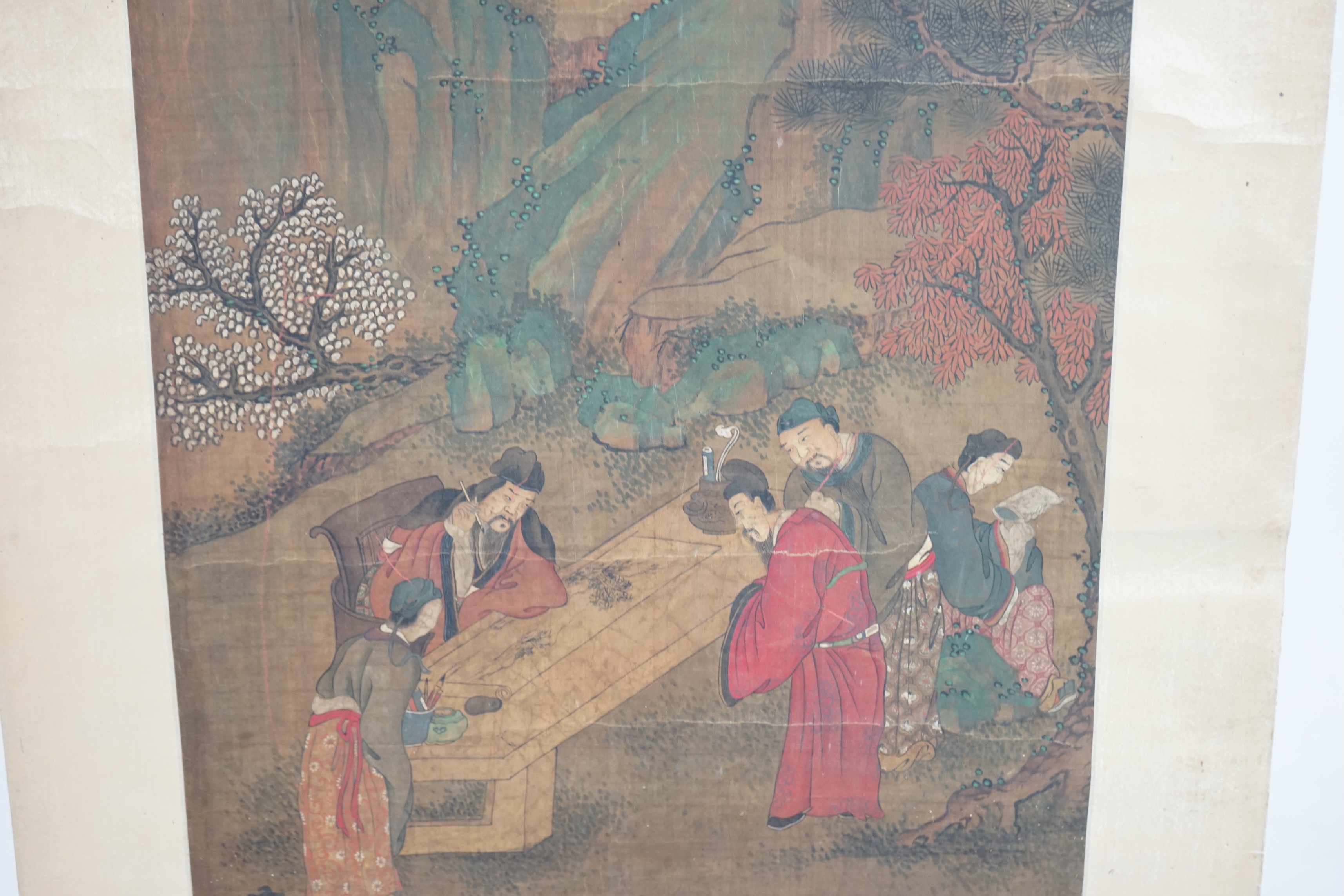 Chinese School, 19th century, scroll painting, ink and colour on silk, scholars in a garden examining a painting